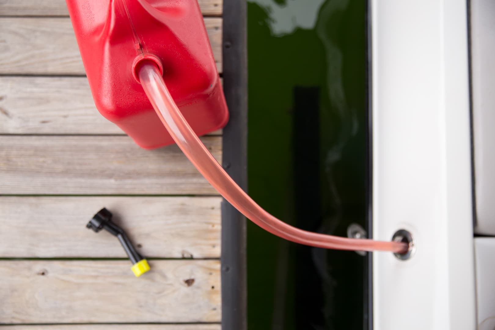 FlowPro siphon transferring fuel from a gas can into a boat at the dock